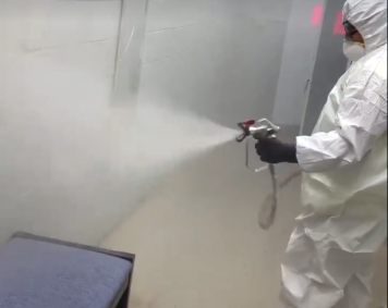 Worker Spraying Disinfectant