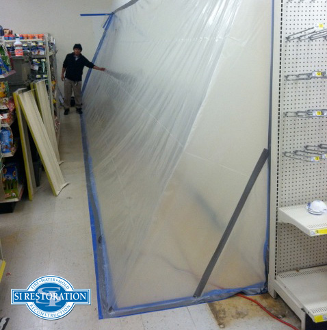 wall covered in sheeting to contain mold